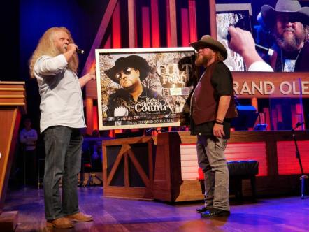 Jamey Johnson Surprises Colt Ford At Grand Ole Opry With RIAA Certified Gold Plaque